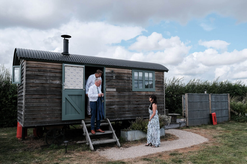 Groomsmen outside Willow Grange shepherds hut