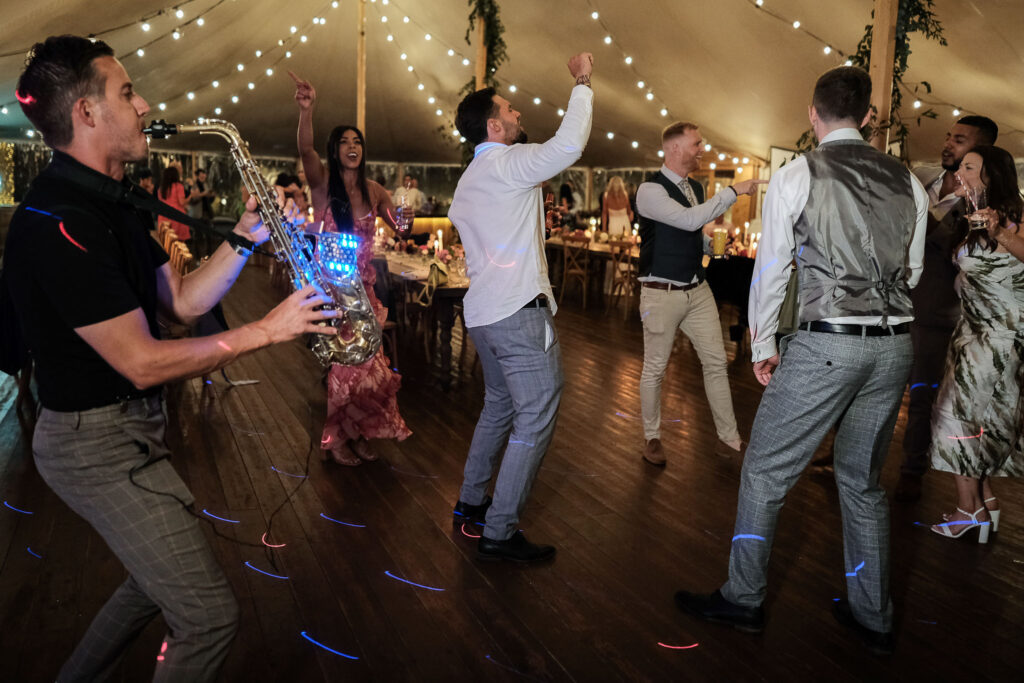 Dance floor action with saxophonist, Willow Grange farm wedding