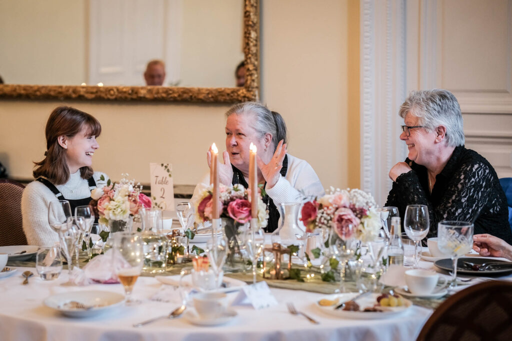 Guests smiling at Fawsley Hall wedding reception