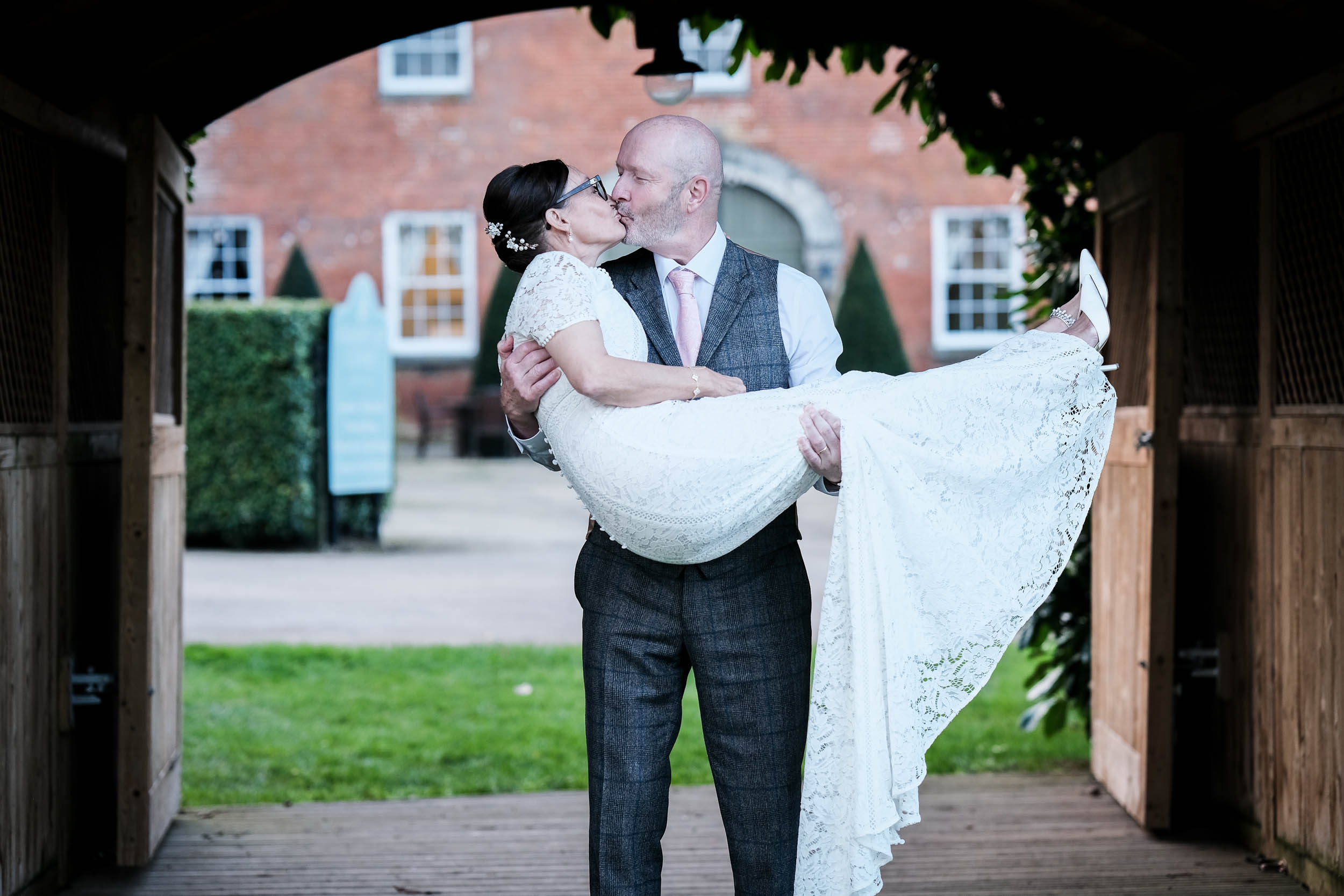 Groom carrying bride and kissing