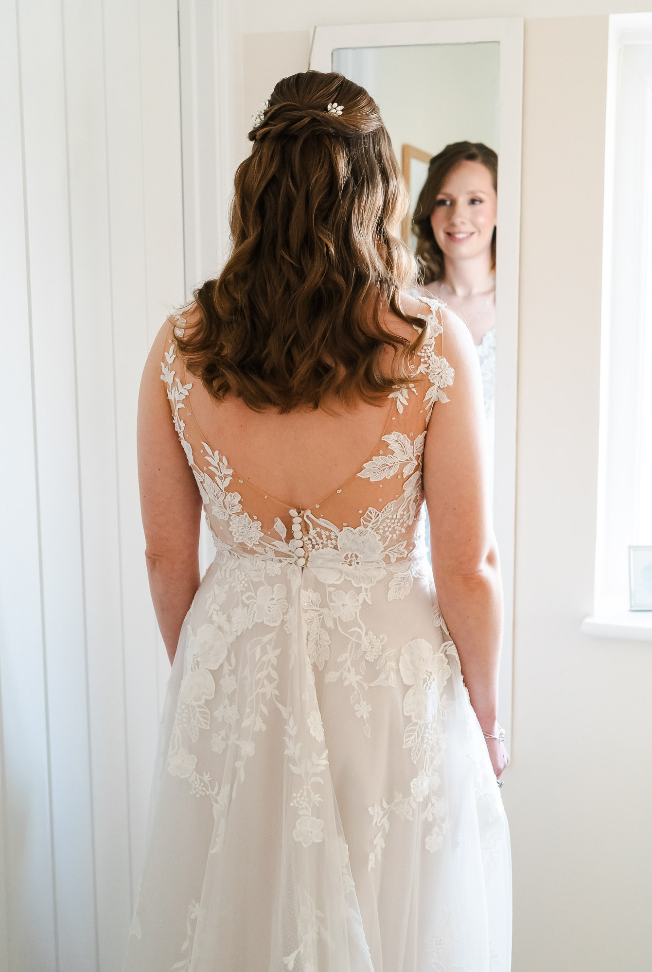 bride and groom in front of colourful blue background smile and kiss on their fun wedding day taken by alternative wedding photographer Glasgow