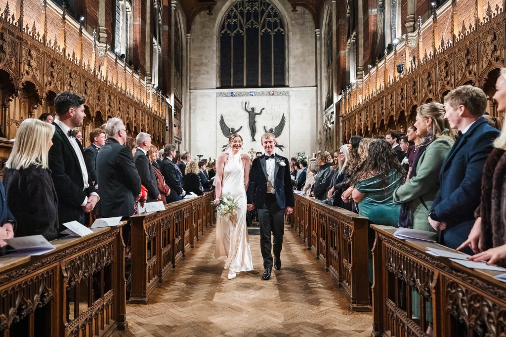 Bride and groom walking down the aisle, Selwyn College chapel, Cambridge wedding photography