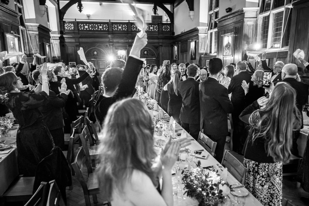 Bride and groom entrance at Selwyn College reception, Cambridge wedding photography