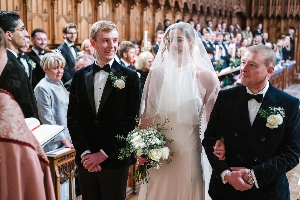 Bride and groom at the front of Selwyn College chapel, Cambridge wedding photography