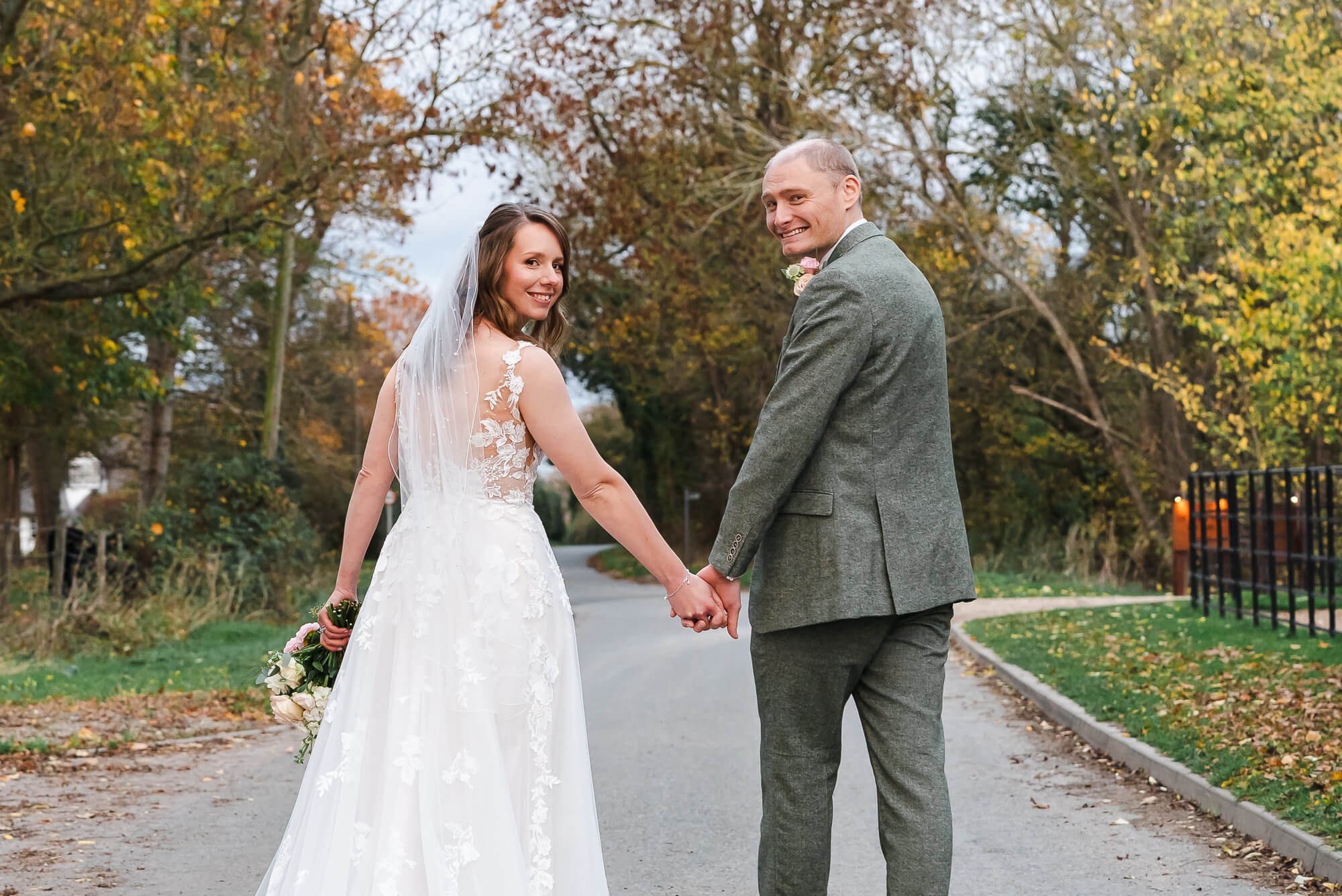 Couple walking outside Manor Barn Cambridge wedding