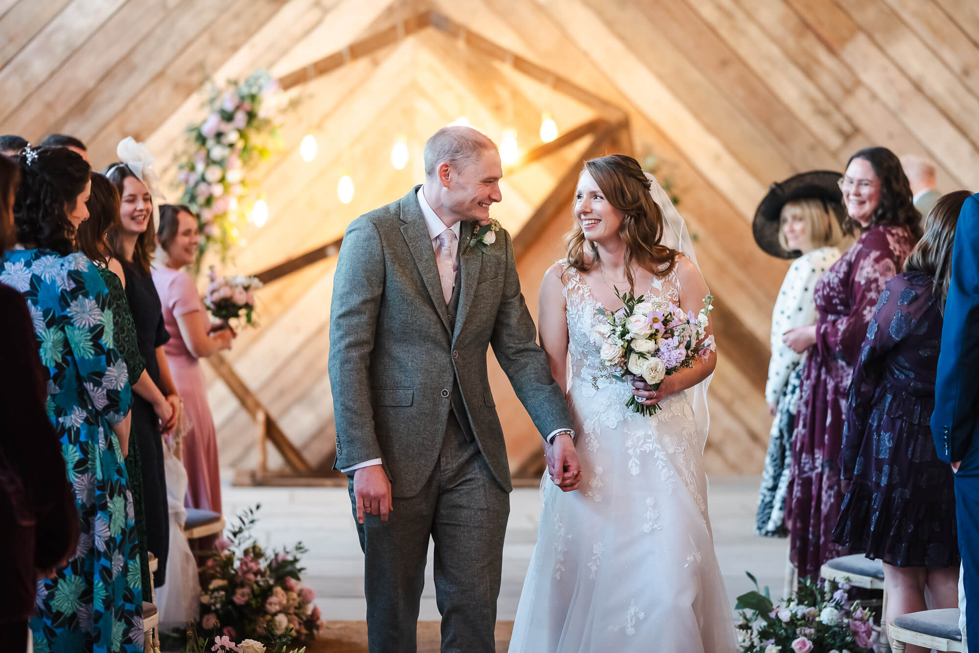 Couple walking down the aisle at Manor Barn Harlton wedding, Cambridge