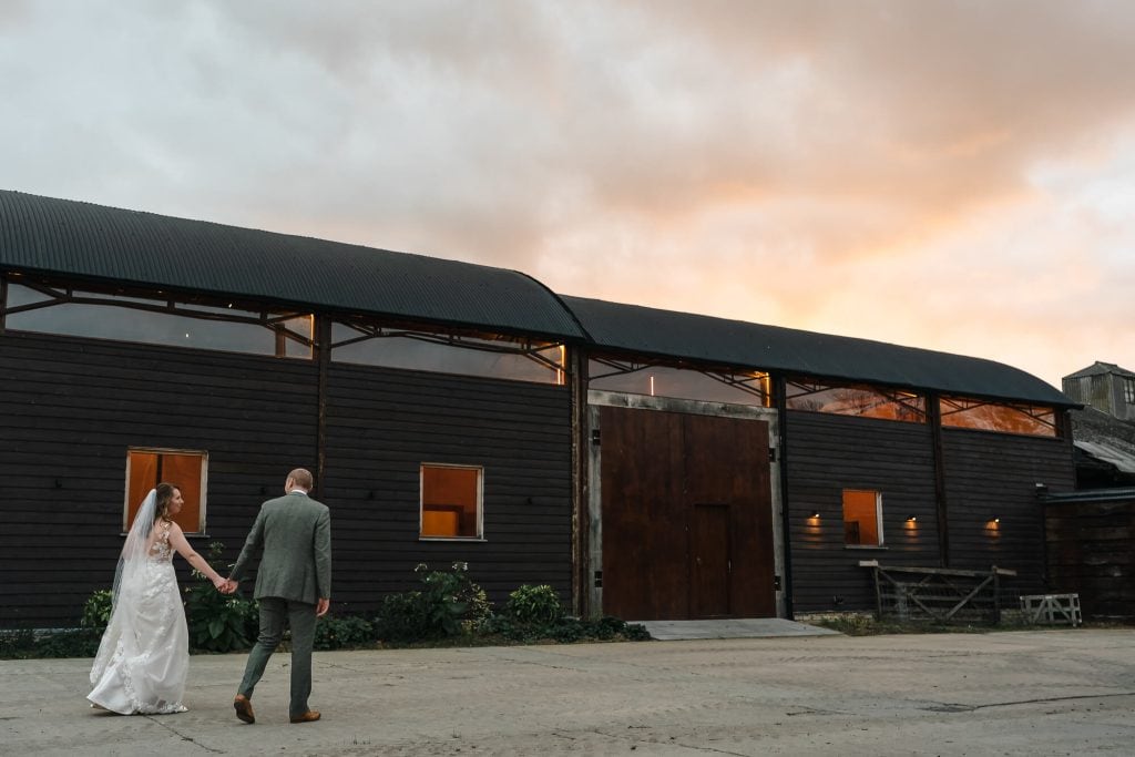 Outside Manor Barn Harlton wedding at sunset